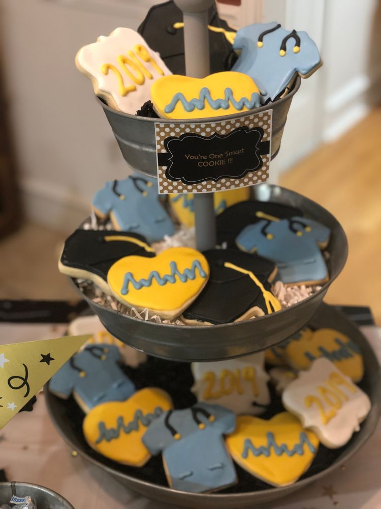 Blue and Yellow Nurse Grad Cookies on a tiered stand