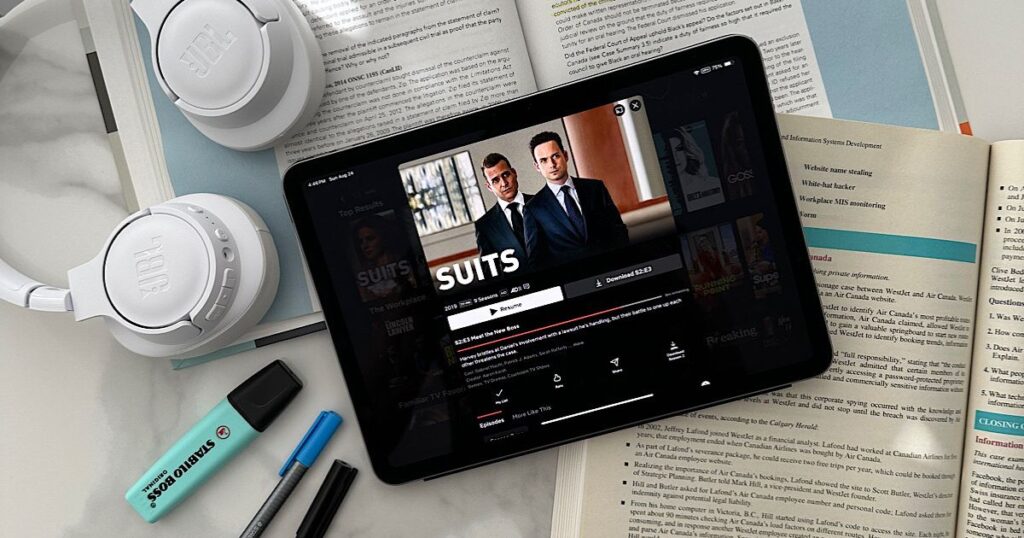 The Netflix series suits displayed on an iPad on top of law textbooks
