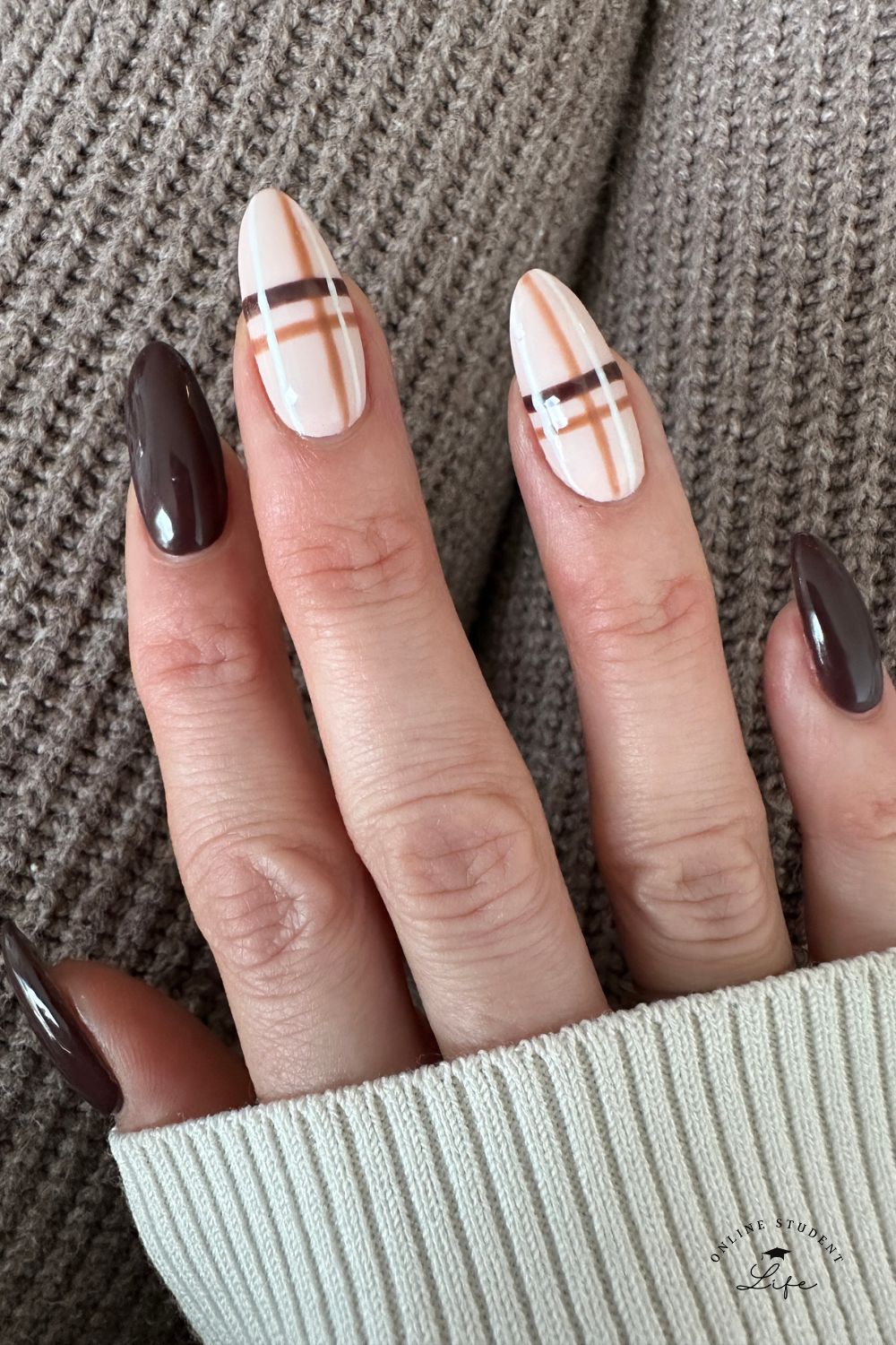 Dark brown nails with plaid nail design on middle and ring fingers.