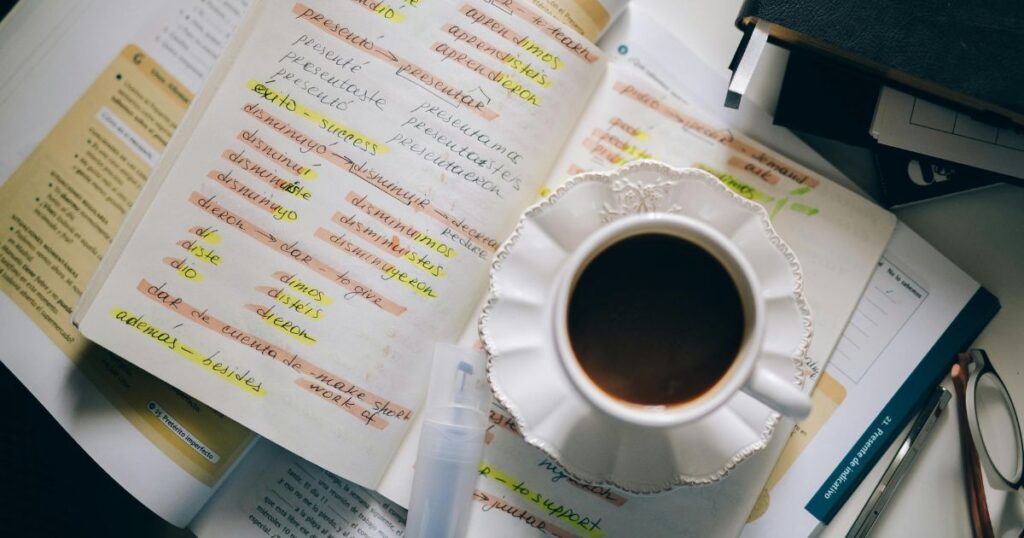 A coffee cup on top of books of a student studying