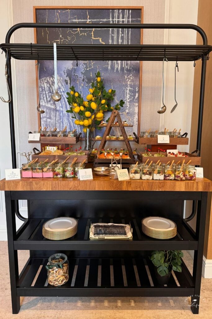 A serving station with individual servings of food in small jars.