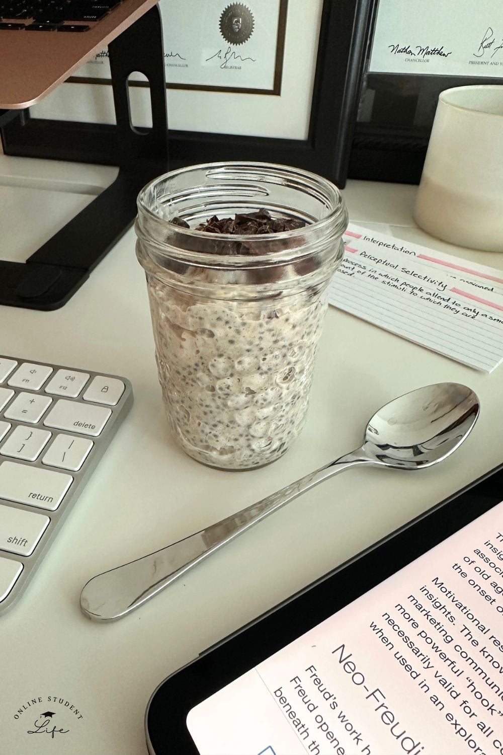 Chocolate chip overnight oats jar on a study desk.